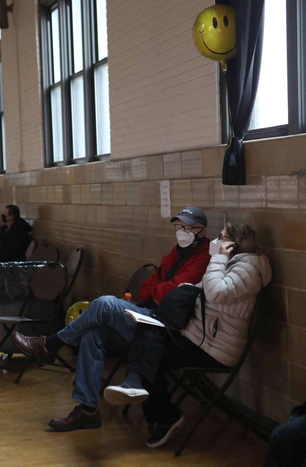 Mike and Paula Hopkins sit in a waiting area